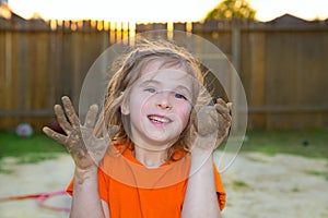 Children girl playing with mud sand ball and dirty hands