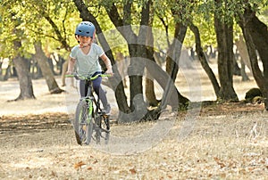Children girl riding bicycle in forest