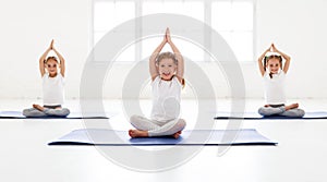 Children girls doing yoga and gymnastics in gym