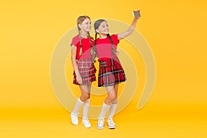 Children girls hold smartphone. Taking selfie photo. Fashion blog. Blog online. Smartphone application concept. Blogger