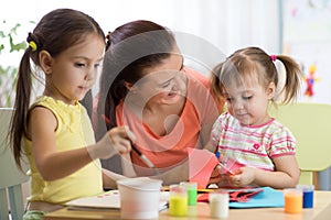 Children girls and mother hands making at nursery at home