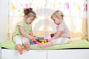 Children girls play together indoors