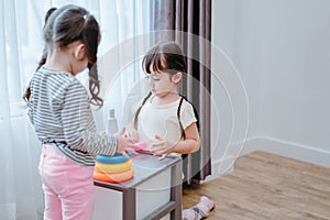 Children girls play a toy games in the room