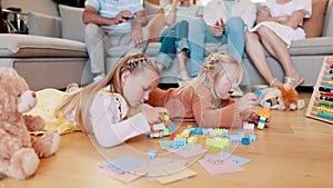 Children, girls and playing with building blocks in living room of home for child development and creative fun. Family