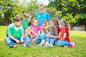 Children with a globe are learning geography