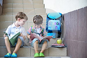 Children go back to school. Start of new school year after summer vacation. Two Boy friends with backpack and books on first schoo