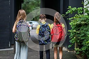 Children go to school for study. Classmates with backpacks. Concept of school, study, education