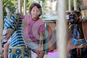 Children going on Merry Go Round, kids play on carousel