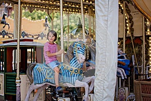 Children going on Merry Go Round, kids play on carousel