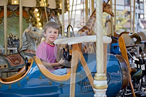 Children going on Merry Go Round, kids play on carousel