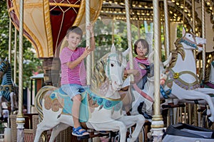 Children going on Merry Go Round, kids play on carousel