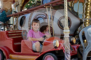 Children going on Merry Go Round, kids play on carousel