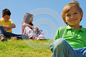 children on a grassy hill