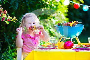 Children grilling meat. Family camping and enjoying BBQ. photo