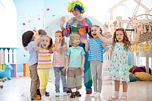 Children group with clown celebrating birthday party
