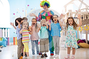 Children group with clown celebrating birthday party