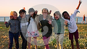 Children group, diversity embrace and smile in park, wave hands and summer by ocean on school trip. Happy multicultural