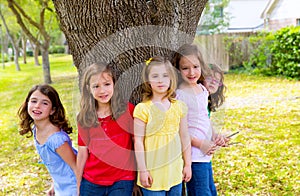 Children group friend girls playing on tree