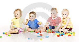 Children group playing toy blocks. Small Kids on w