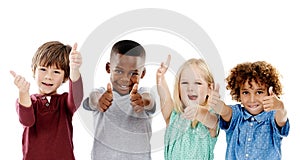 Children, group and thumbs up for diversity in studio portrait with smile, agreement and white background. Girl, boy or