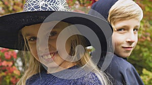 Children in Halloween costumes posing for camera, preparation for scary party