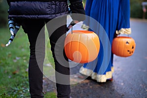 Children with Halloween pumpkin baskets