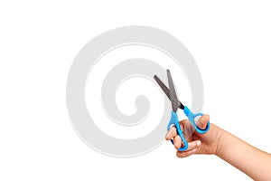 Children hand with blue little scissors, kids educational work