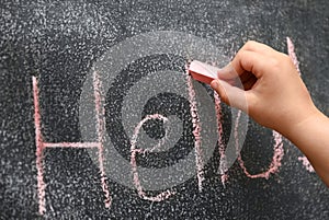 Children hand learn to write on the drawing board