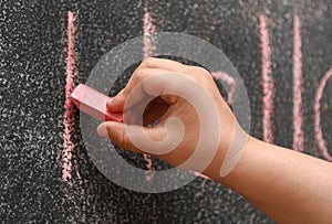 Children hand learn to write on the drawing board