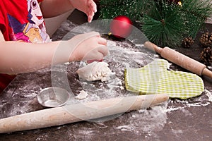 Children hand makes cookies for Christmas