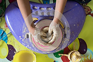 Children hand playing with clay to make pottery