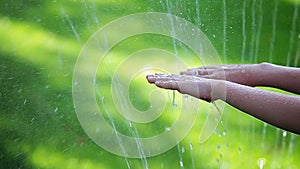 Children hand water drop grass background