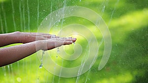 Children hand water drop grass background