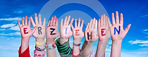 Children Hands Building Word Erziehen Means Educate, Blue Sky