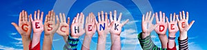 Children Hands Building Word Geschenk Idee Means Gift Idea, Blue Sky photo