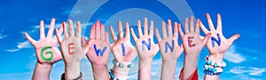 Children Hands Building Word Gewinnen Means Win, Blue Sky photo