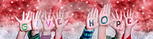 Children Hands Building Word Give Hope, Red Christmas Background