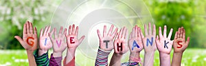 Children Hands Building Word Give Thanks, Grass Meadow photo