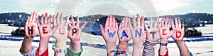 Children Hands Building Word Help Wanted, Snowy Winter Background