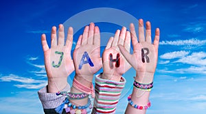 Children Hands Building Word Jahr Means Year, Blue Sky photo