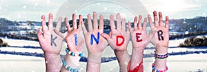 Children Hands Building Word Kinder Means Kids, Snowy Winter Background