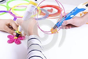 Kids hands creating new 3d object with 3d pen. Learning and entertainment at home