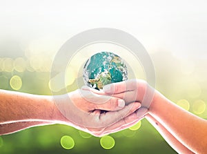 Children hands holding earth global