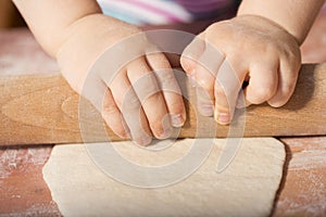 Children hands kneading dough