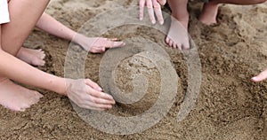 Children hands play and build sand castles on beach