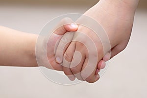 Children hands together holding - childhood friendship concept
