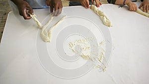 Children hands view from above preparing bread dough