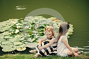 Children happy smile on green lake landscape. Germination and growth