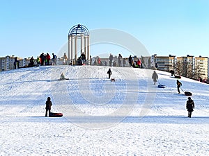 children have fun in winter joy to slide down the mountain on a sunny day day off winter health fresh air