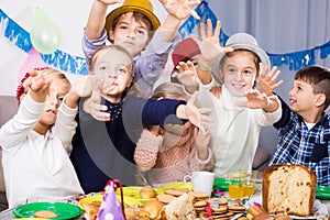 Children having celebration of friend birthday during dinner